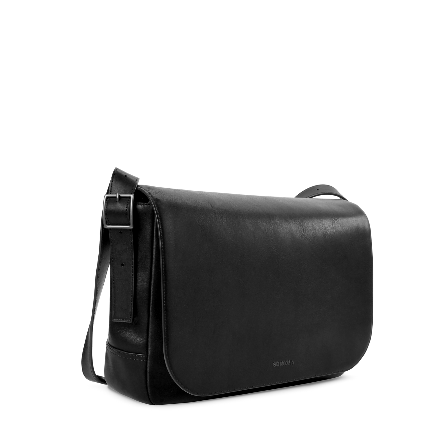 The Shinola Runwell Messenger Bag in sleek black leather features a large front flap, adjustable crossbody strap, minimal stitching, and padded laptop sleeve, shown against a plain white background.