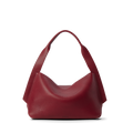 The Shinola Medium Derby Shoulder Bag - Ruby is a textured, natural grain leather handbag in deep red with wide handles. It has a slouchy, soft structure and no visible hardware or embellishments, shown upright on a white background.