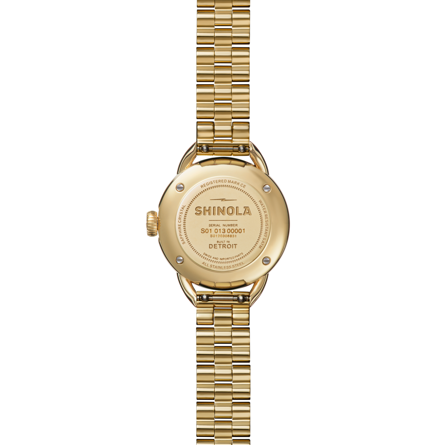 A Shinola Runabout Watch - Petoskey is shown face down, revealing its engraved back case with brand name, serial numbers, and a metal link band. This watch is assembled in Detroit.