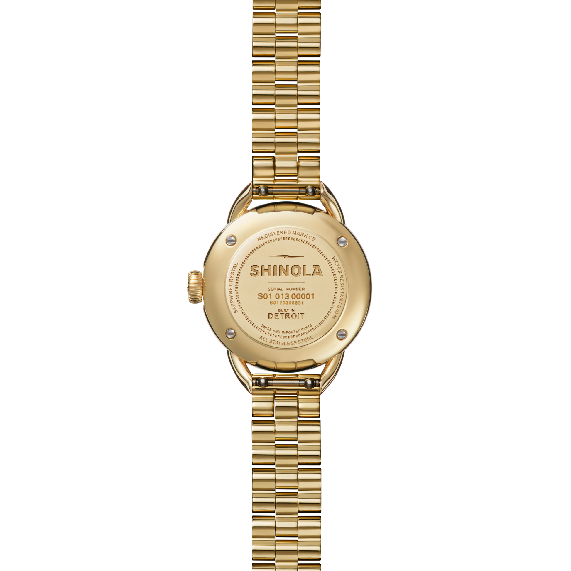 A Shinola Runabout Watch - Petoskey is shown face down, revealing its engraved back case with brand name, serial numbers, and a metal link band. This watch is assembled in Detroit.