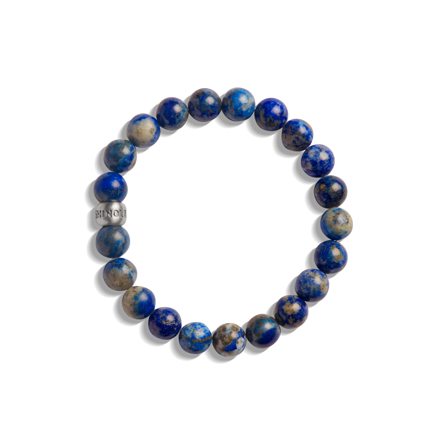The 8mm Beaded Lapis Bracelet by Shinola features round blue and gray marbled lapis stones with a small engraved metallic bead, arranged in a circle—an elegant gemstone accessory.