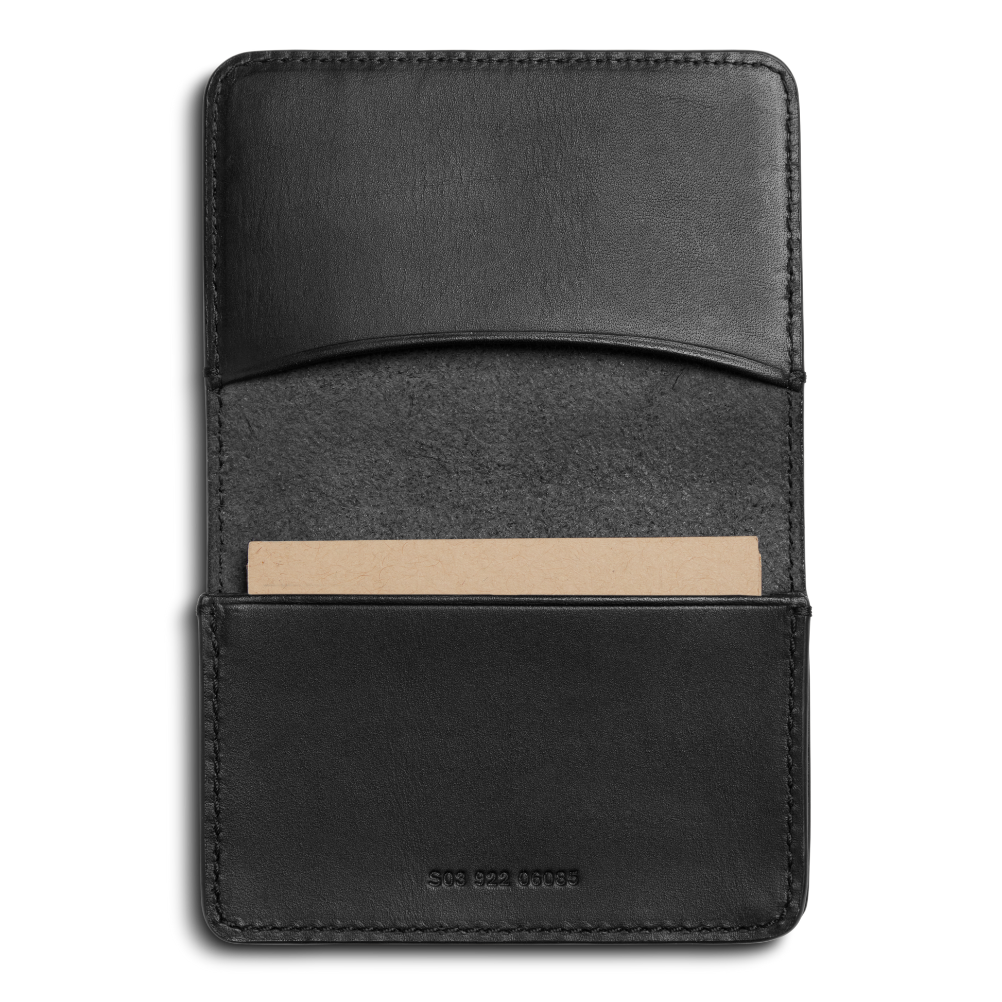 The Shinola Business Card Holder - Black, crafted from Italian leather with two pockets and holding a brown card, is displayed open against a light background—timeless elegance for professionals.