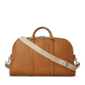 The Shinola Runwell Duffle Bag in tan leather features silver hardware, two short handles, and a detachable beige shoulder strap—ideal as a stylish travel bag or TSA carry-on, shown on a plain white background.
