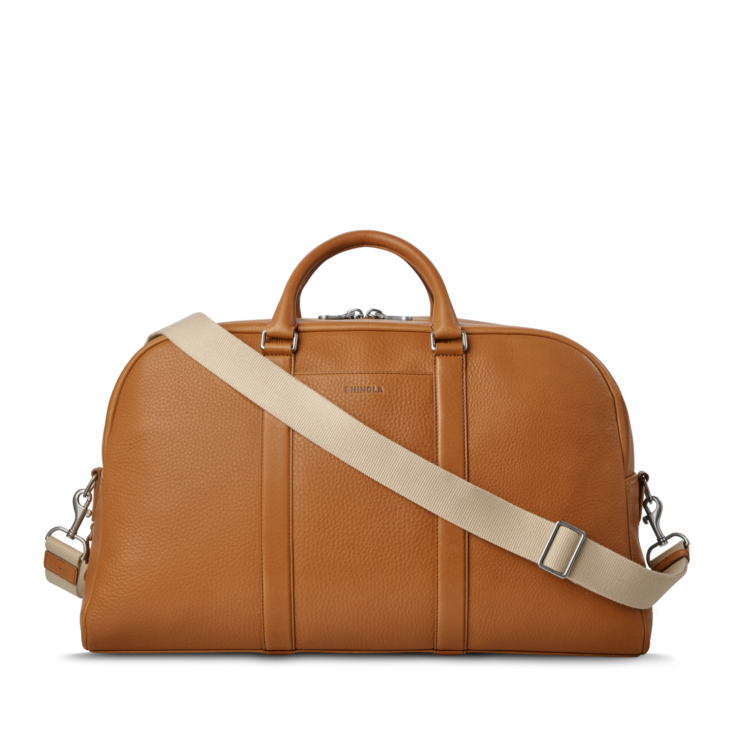 The Shinola Runwell Duffle Bag in tan leather features silver hardware, two short handles, and a detachable beige shoulder strap—ideal as a stylish travel bag or TSA carry-on, shown on a plain white background.