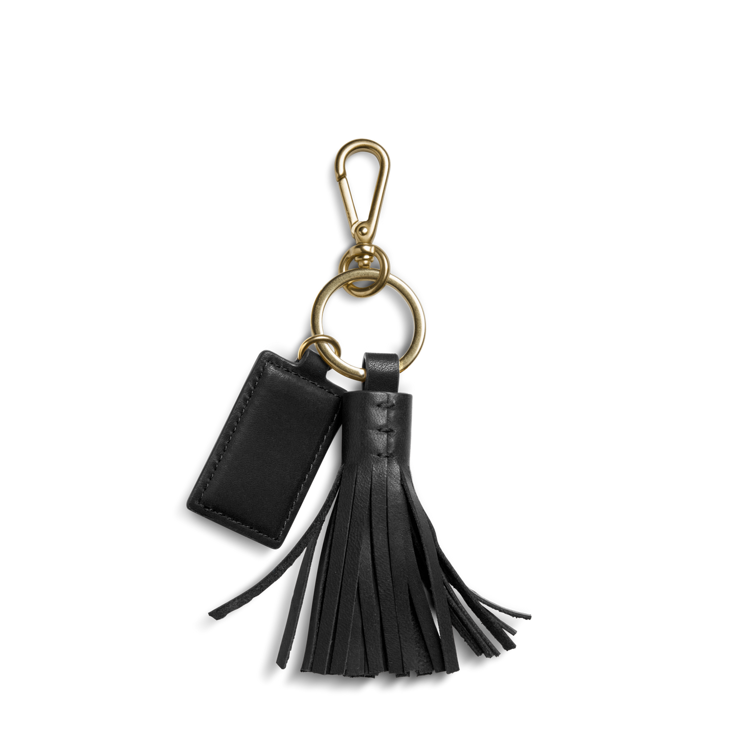The Shinola Leather Tassel Keychain - Black features a black leather key fob with a gold clip, small rectangular tag, and decorative tassel on a gold keyring, displayed against a white background.