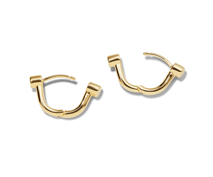 The Shinola Diamond Bike Lock Huggie Earrings in yellow gold feature a modern, angular hoop design and are displayed on a white background.