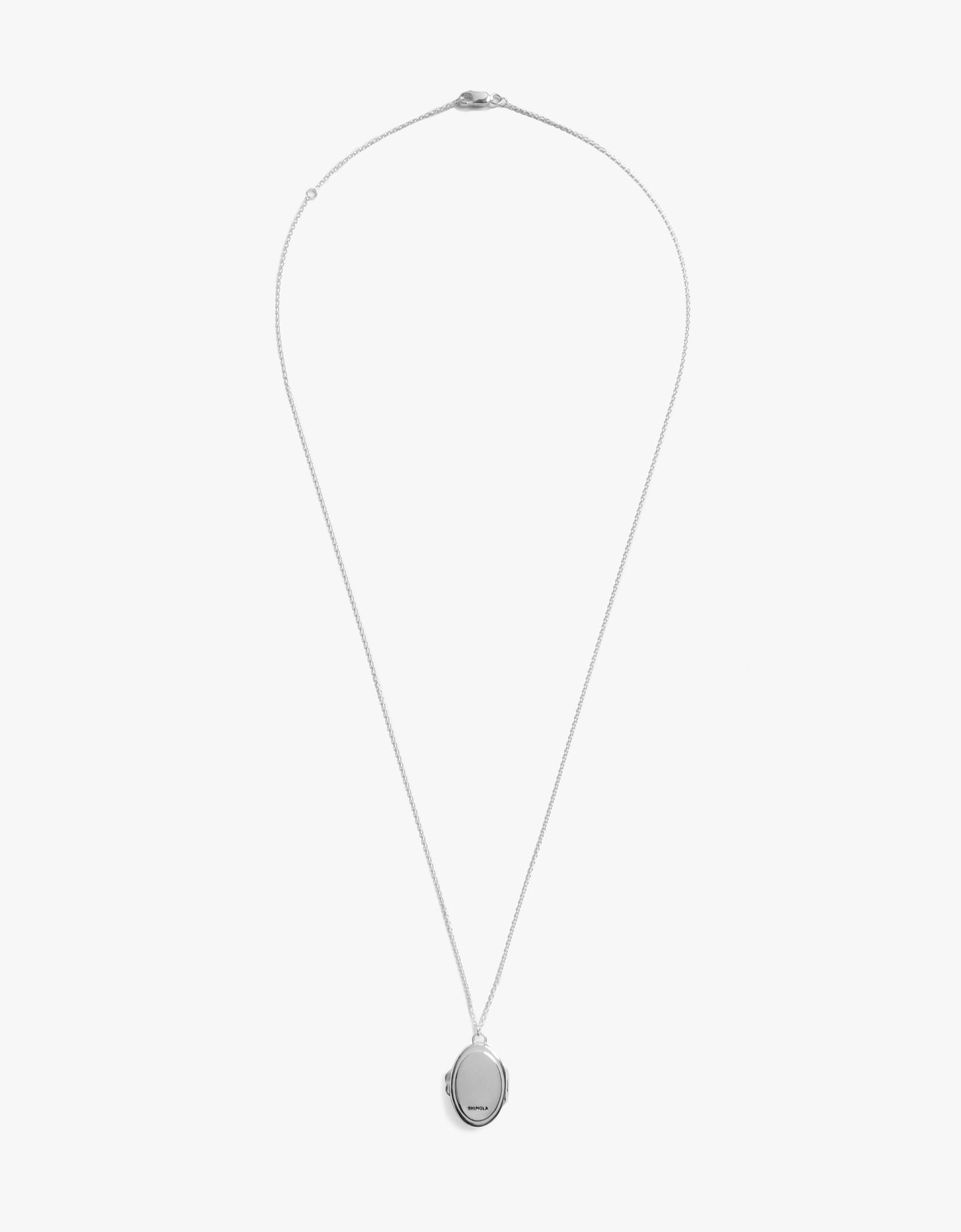 The Shinola Heirloom Statement Locket Necklace in sterling silver showcases an engravable oval pendant on a delicate chain, displayed against a plain white background.