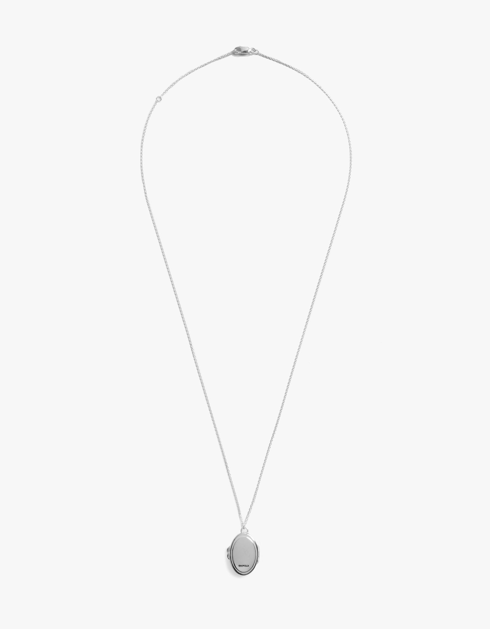 The Shinola Heirloom Statement Locket Necklace in sterling silver showcases an engravable oval pendant on a delicate chain, displayed against a plain white background.