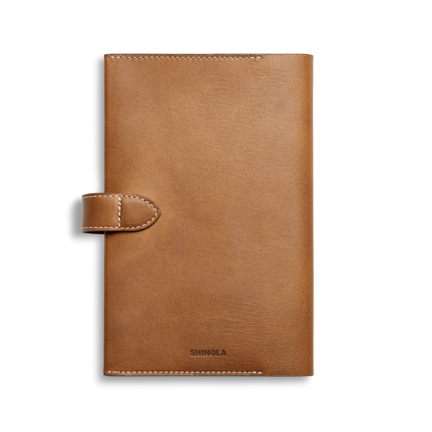 A tan Vachetta leather Medium Snap Journal Cover by Shinola, featuring a button snap closure and visible stitching with the brand embossed at the bottom, is shown against a plain white background.