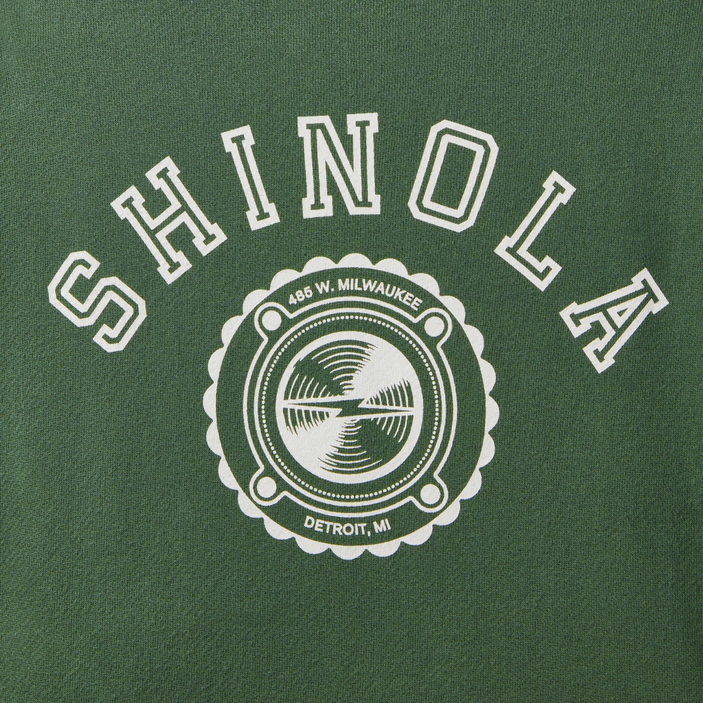 The Shinola Logo Sweatshirt - Leaf is a green French Terry unisex sweatshirt by Shinola, featuring bold SHINOLA text and a circular logo with "486 W. MILWAUKEE, DETROIT, MI" above a watch movement graphic.