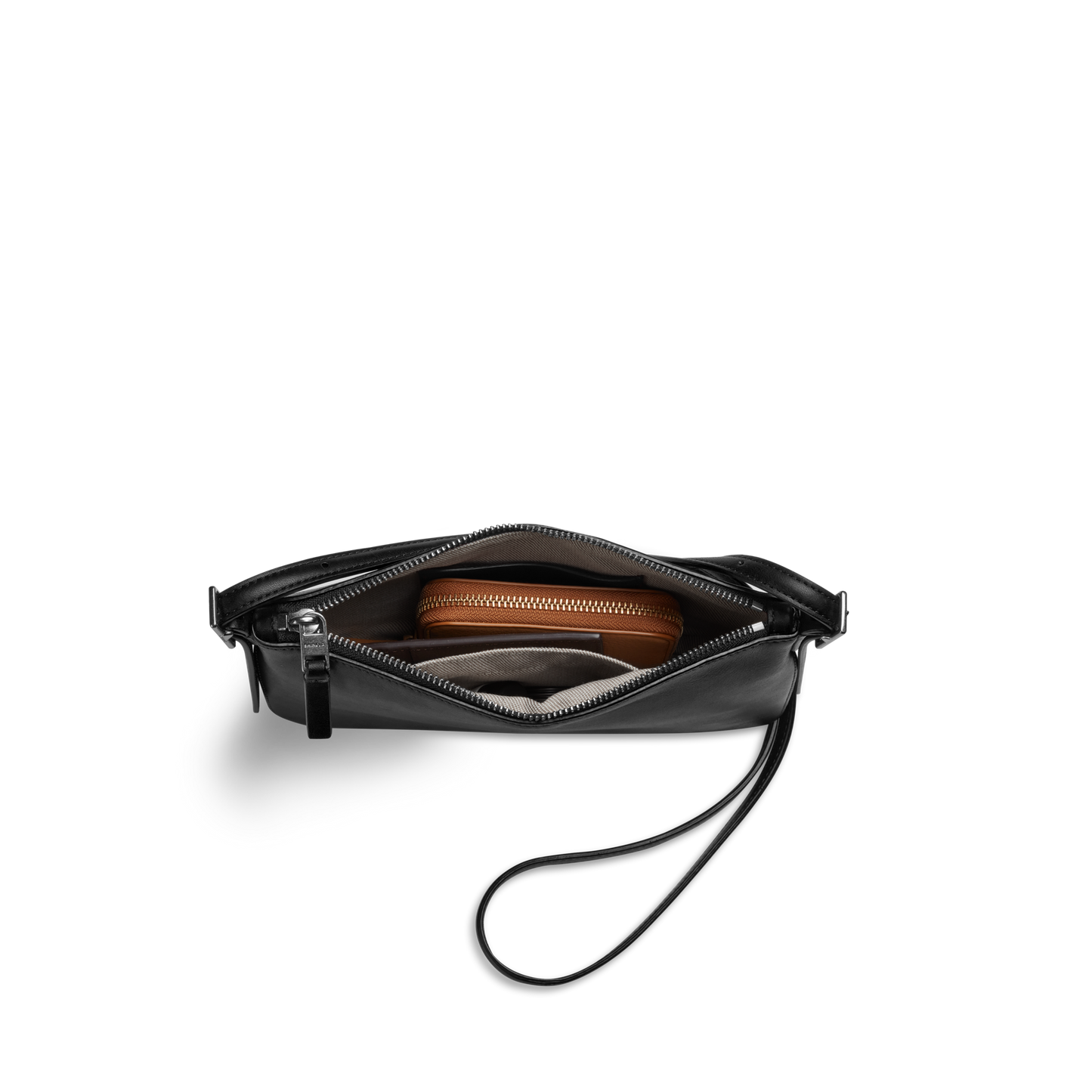 The Shinola Small Bixby Crossbody in black natural leather, shown partially unzipped to reveal a brown wallet and small gray item inside, makes the perfect everyday accessory against a plain white background.