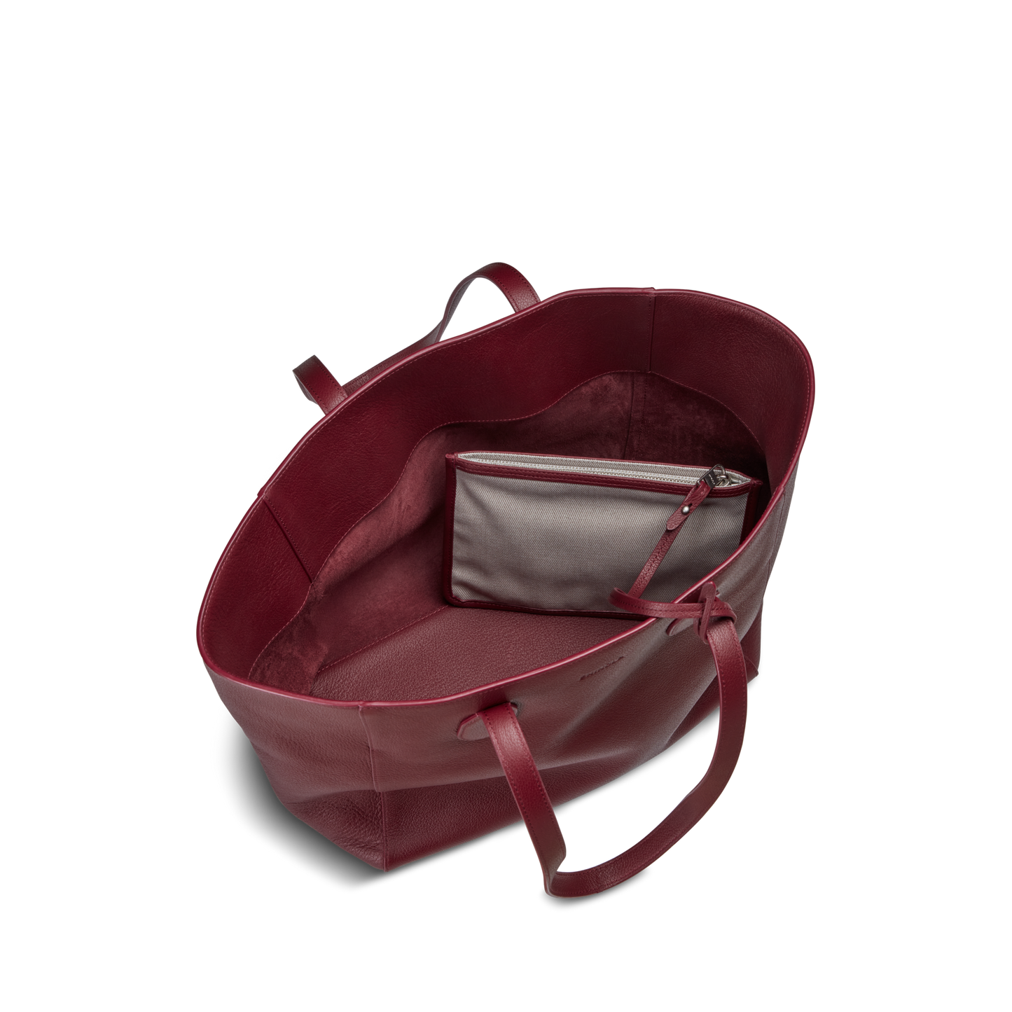 The Shinola Runabout Tote Bag - Ruby is a spacious, open tote crafted from lightweight pebbled leather with two handles and an interior gray zipper pouch, shown against a plain white background.