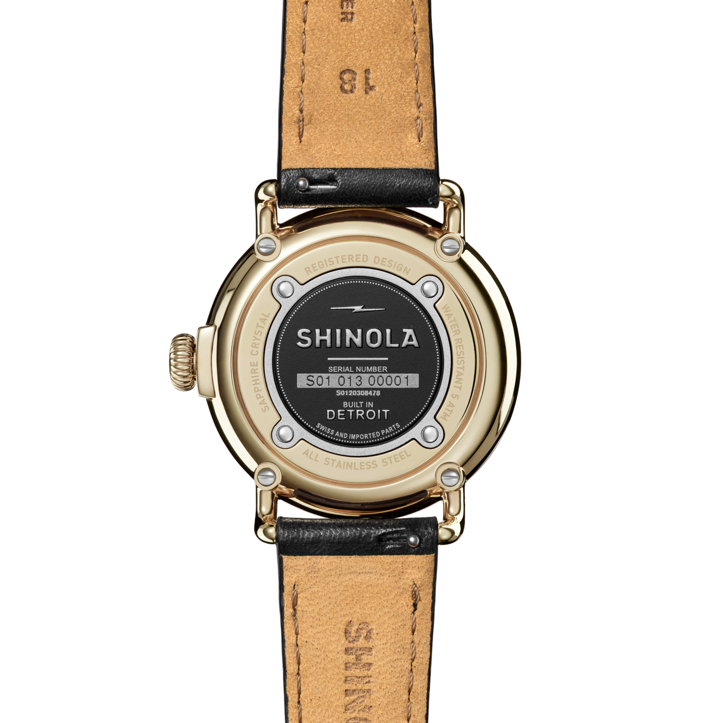 The back of the Shinola Runwell Watch - Alabaster features a gold stainless steel case, black leather strap, and displays the brand name, serial number, and “Built in Detroit.”.