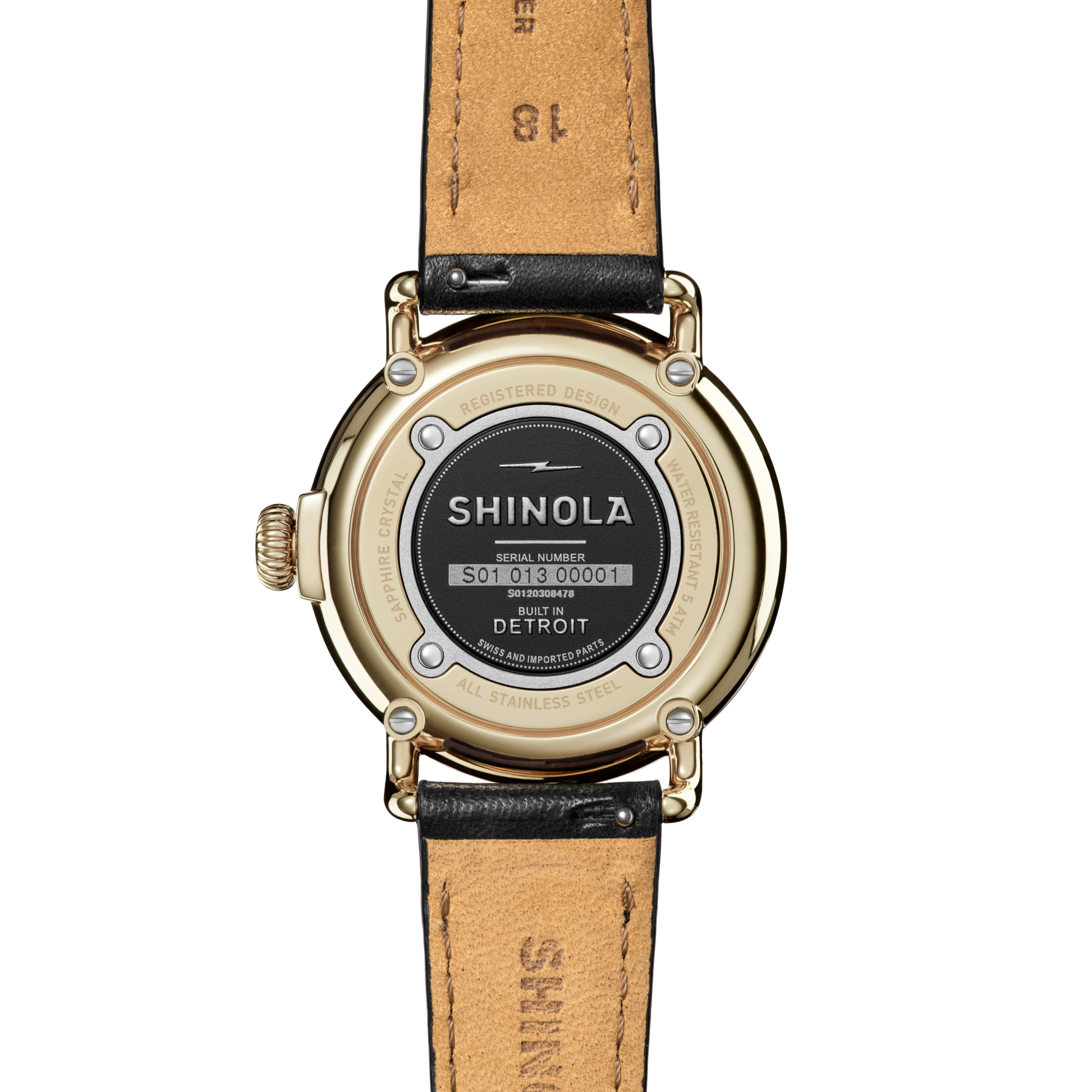 The back of the Shinola Runwell Watch - Alabaster features a gold stainless steel case, black leather strap, and displays the brand name, serial number, and “Built in Detroit.”.