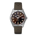 The Shinola Duck Watch - Mallard Brown features a brown gradient dial, silver hour markers, luminous hands, a silver bezel with black numerals, and a textured brown strap with Shinola and Detroit branding.