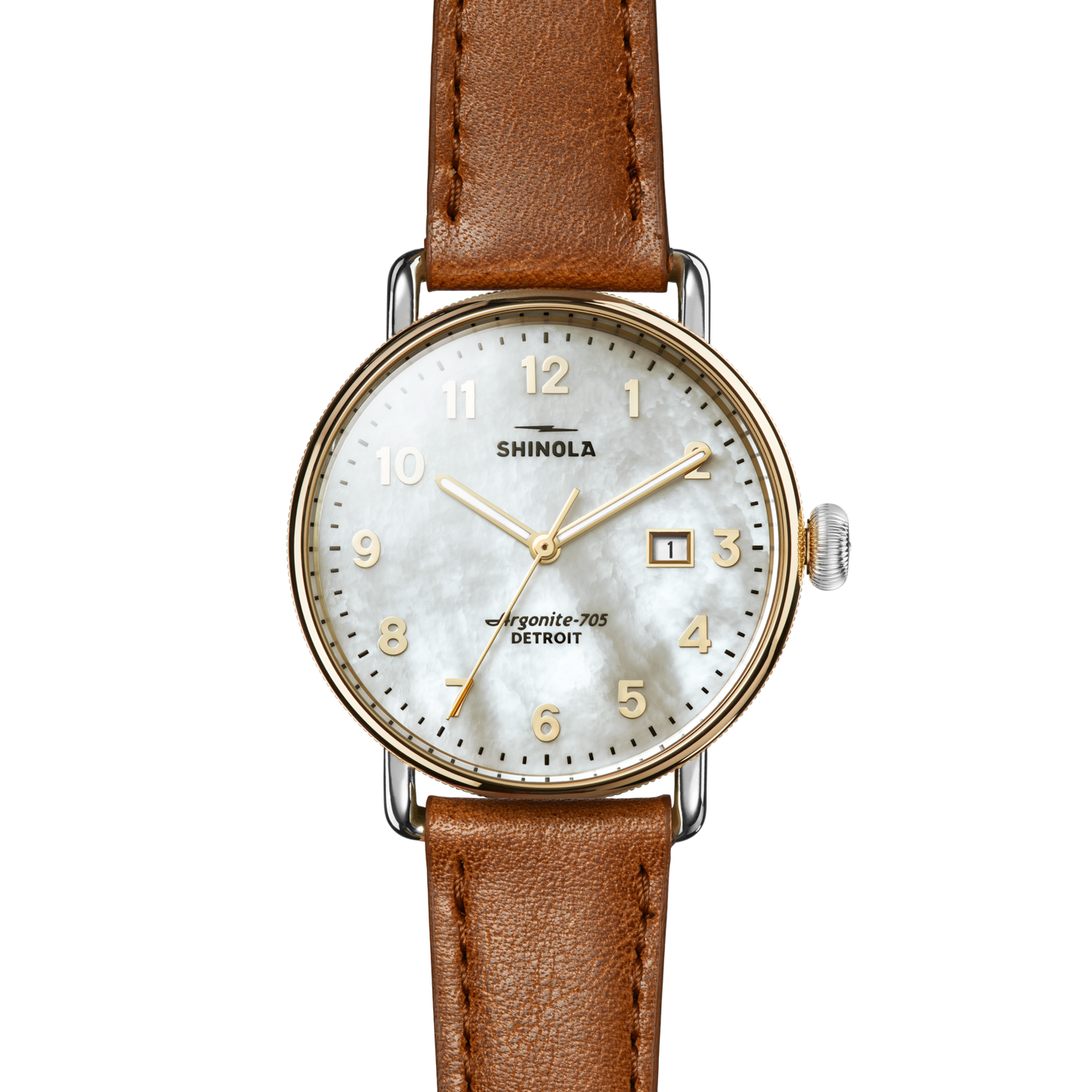 The Shinola Canfield Watch features a tan leather strap, white textured dial with gold numerals and hands, date window at 3 o’clock, silver crown, and text reading “Shinola” and “Argonite-705 Detroit.”.