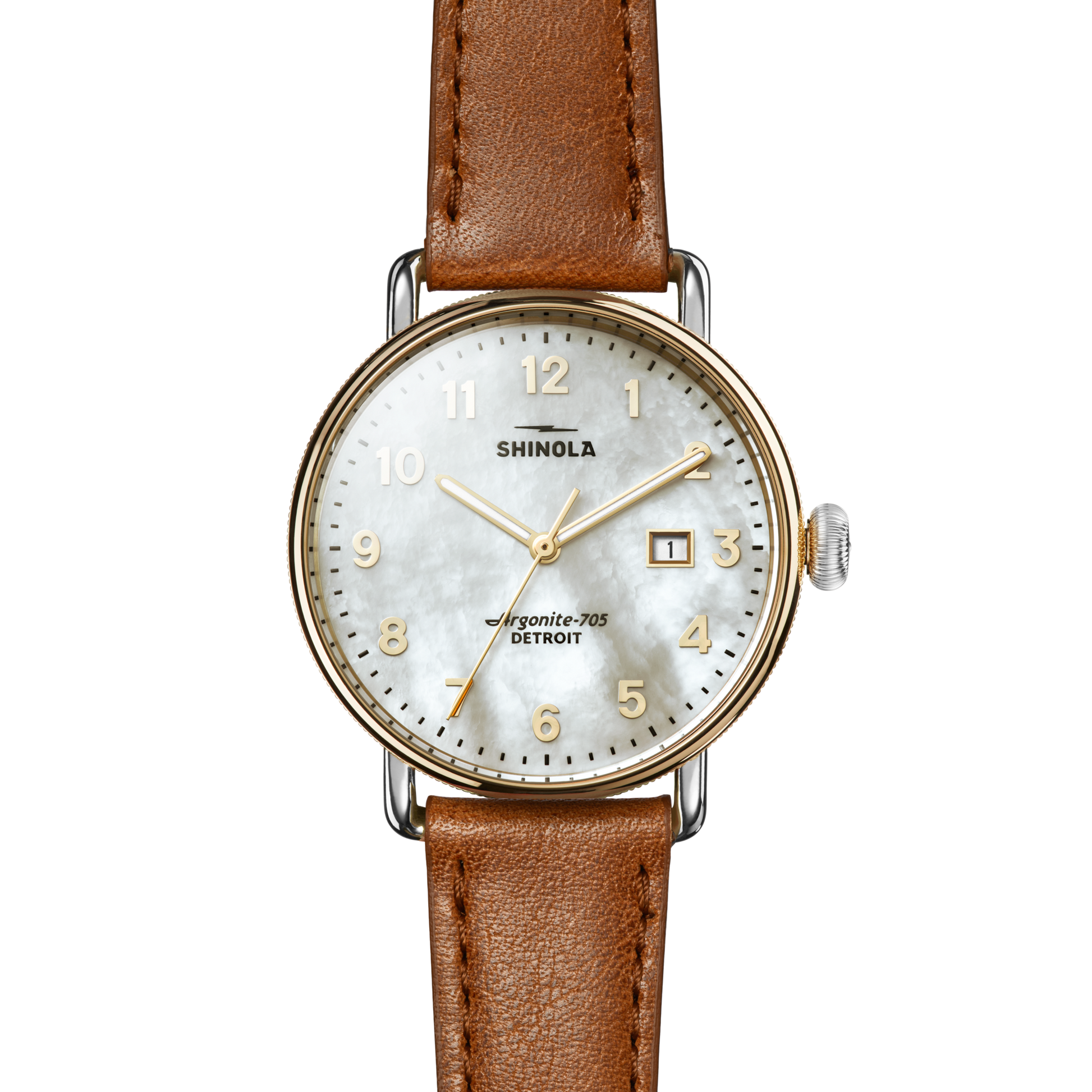 The Shinola Canfield Watch features a tan leather strap, white textured dial with gold numerals and hands, date window at 3 o’clock, silver crown, and text reading “Shinola” and “Argonite-705 Detroit.”.