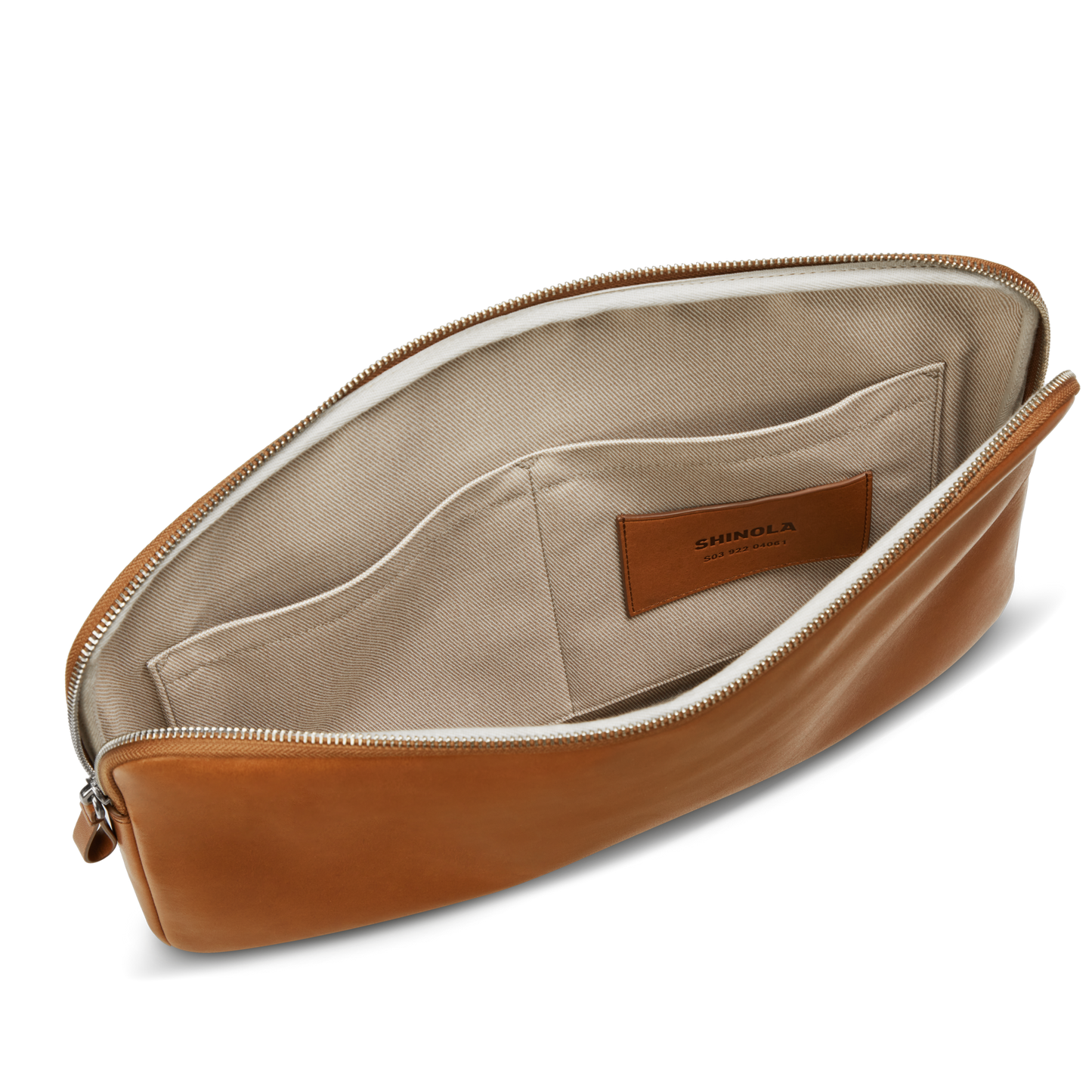 The Shinola Laptop Tech Case - Tan is a tan leather zippered pouch with a beige fabric interior, two inner pockets, and a leather logo patch—an ideal accessory organizer for your daily essentials.