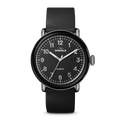 The Shinola Detrola Watch - Black features a round face, white numerals, black band, date window near 3 o’clock, shows 10:09, and “Detroit” on the dial—a durable timepiece with classic American design.