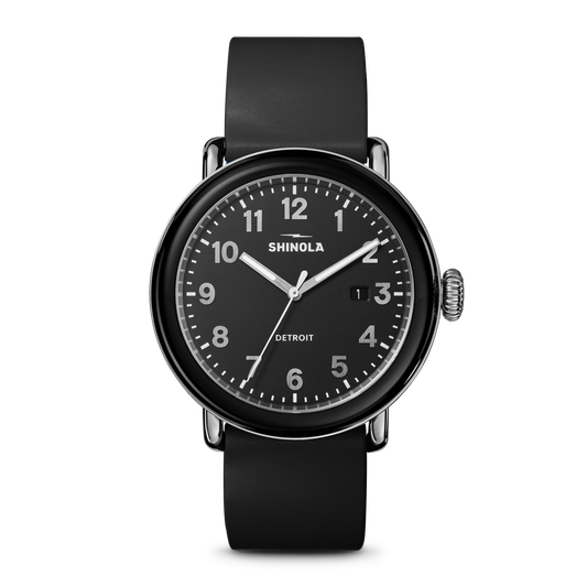 The Shinola Detrola Watch - Black features a round face, white numerals, black band, date window near 3 o’clock, shows 10:09, and “Detroit” on the dial—a durable timepiece with classic American design.