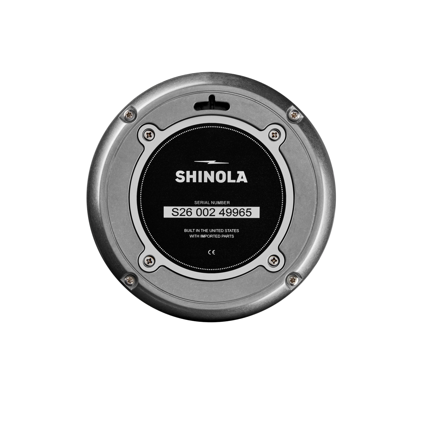 The Shinola 6" Runwell Clock in tumbled zinc features a black center, visible branding, a serial number, "Built in the United States with imported parts" text, and four screws around its industrial metallic edge.
