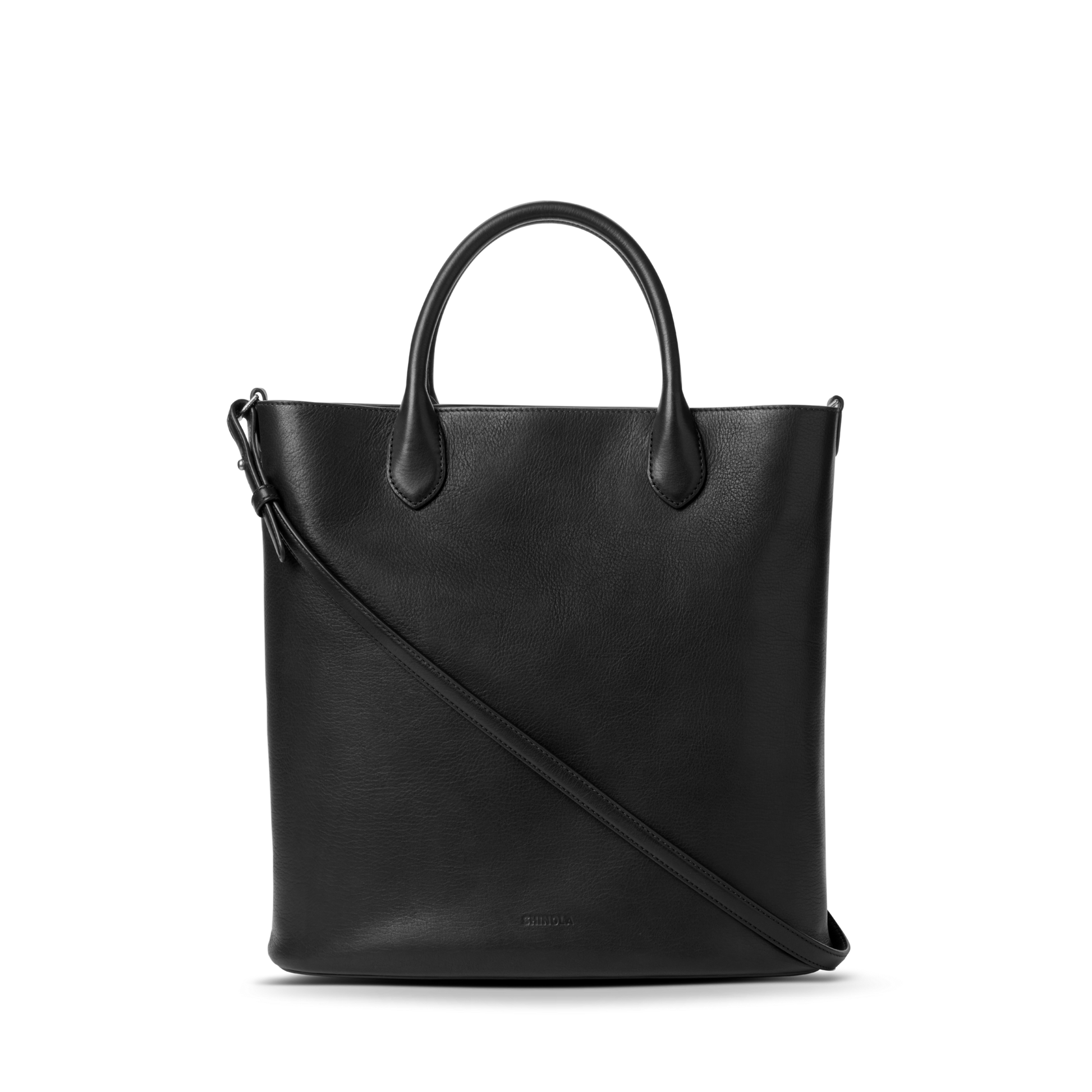 The Shinola 12 Hour Tote Bag - Black features short handles and a long, adjustable shoulder strap—ideal for everyday use—shown against a plain white background.