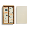 The Dominoes Set - Cream / Blue by Shinola features hand-painted tiles with blue dots and orange lightning bolts, housed in a wooden box next to a closed beige box embossed with the SHINOLA logo.