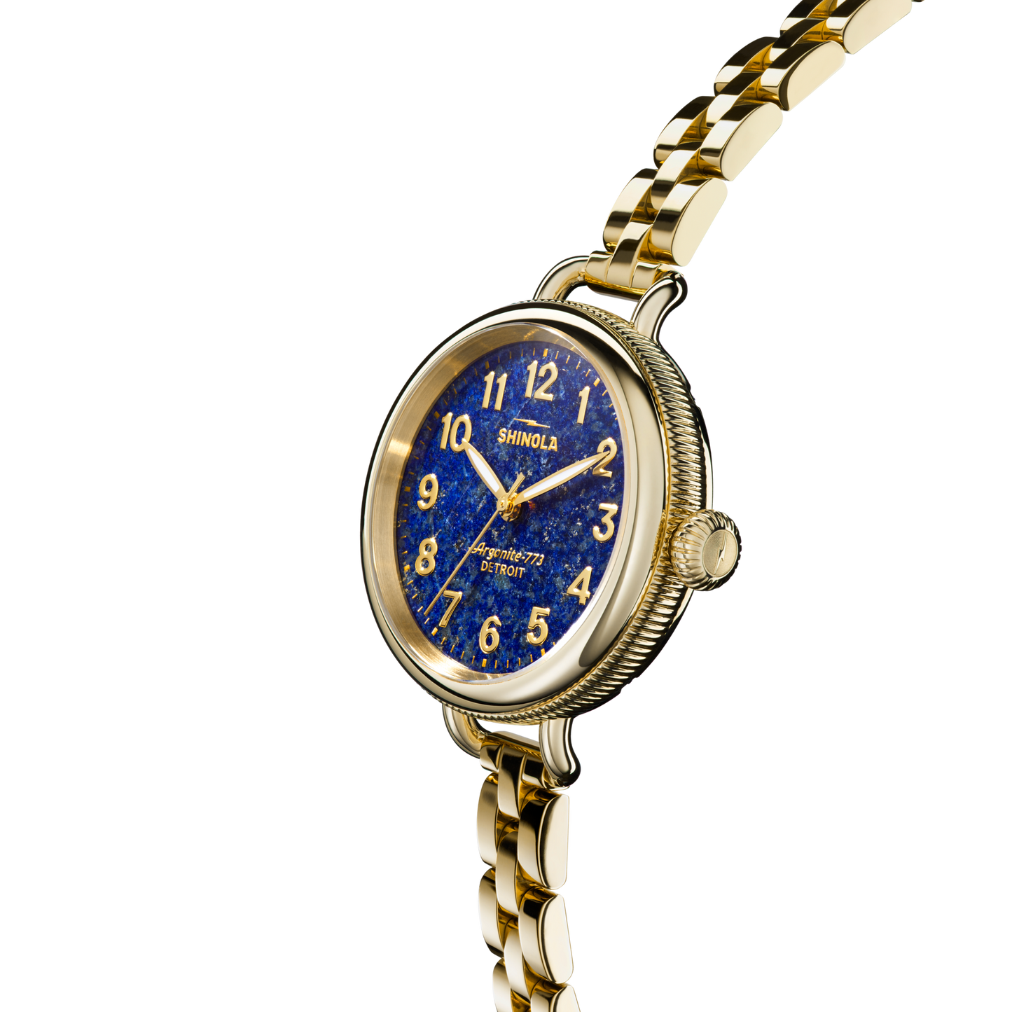 The Shinola Birdy Watch - Lapis, assembled in Detroit, features a gold-tone case, blue lapis-inspired dial with gold numerals, metal link band, textured crown and case, and the Shinola name on the face against a plain white background.