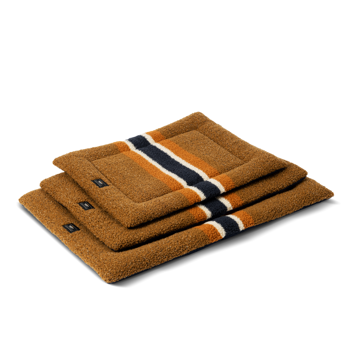 Three rectangular Shinola Crate Comfort Mat - Stripe Brown dog beds are stacked on a plain light background. These striped, machine washable mats provide comfort and style for your pet's space.