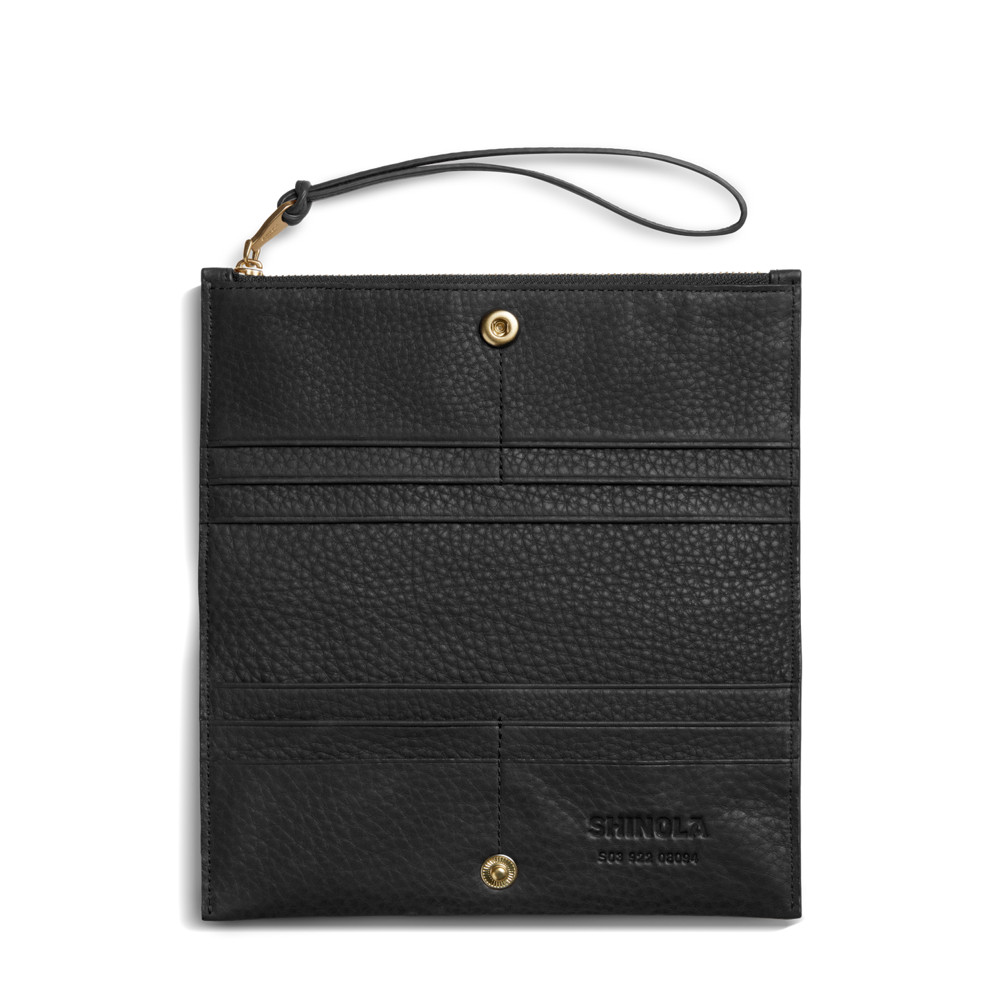The Shinola Wristlet Wallet - Black features natural grain leather, a wrist strap, gold hardware, and multiple card pockets. "Shinola" is embossed on the lower right corner. The wallet is shown flat on a white background.
