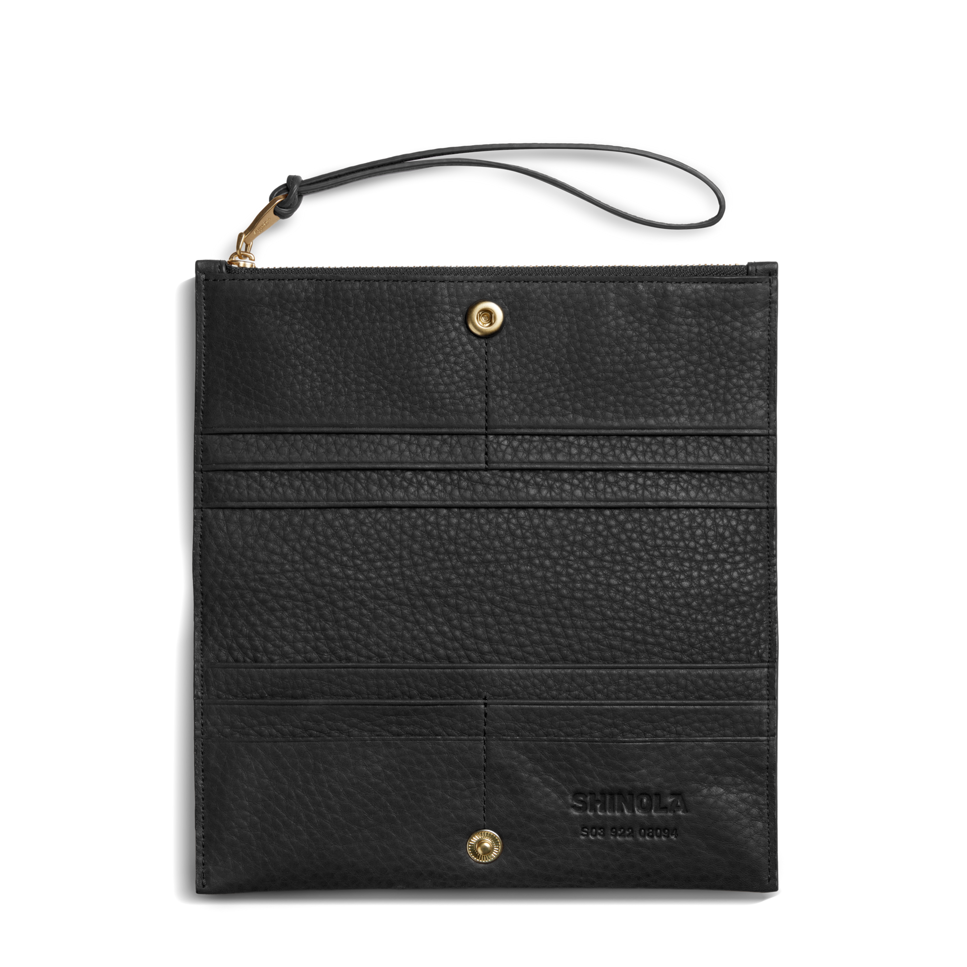 The Shinola Wristlet Wallet - Black features natural grain leather, a wrist strap, gold hardware, and multiple card pockets. "Shinola" is embossed on the lower right corner. The wallet is shown flat on a white background.