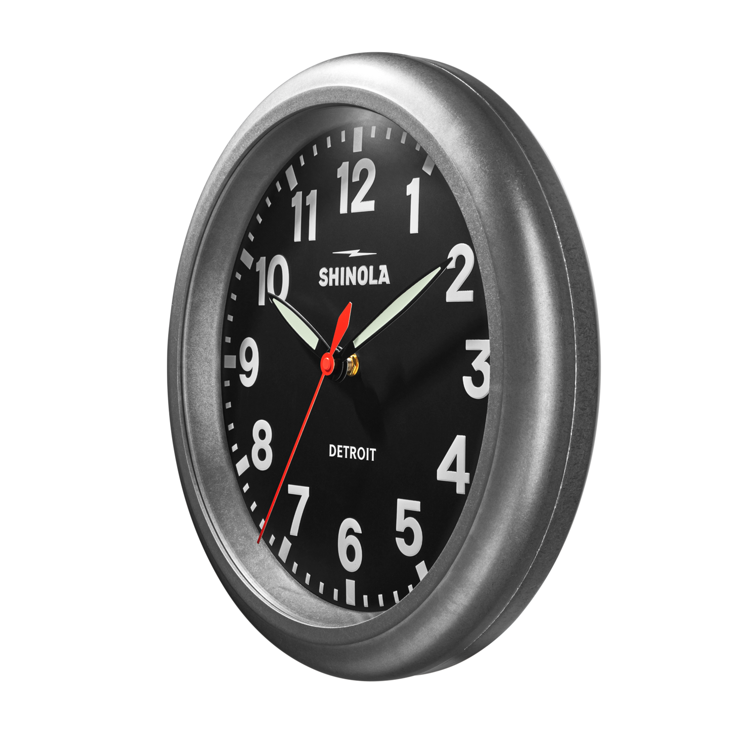The 14" Runwell Clock - Tumbled Zinc/Black by Shinola features an industrial round design with a tumbled zinc case, black face, white numerals and hands. The clock displays the time as 10:09:36 on a plain white background.