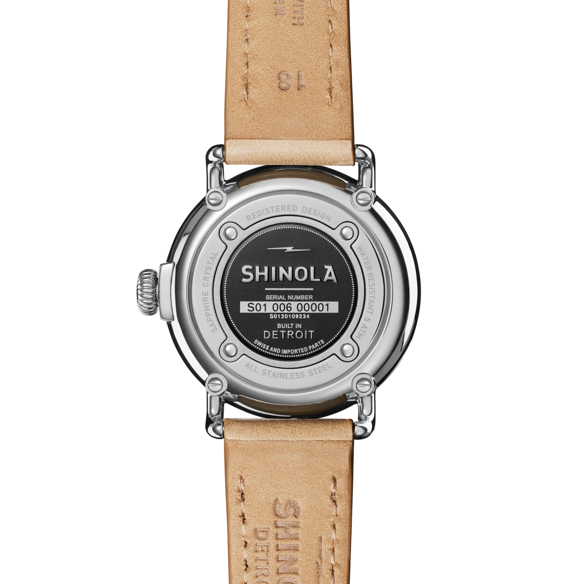 The back view of the Shinola Runwell Coin Edge Watch - Silver shows a round stainless steel case, black center with engravings, and tan leather strap, featuring the serial number and "Built in Detroit" inscription.