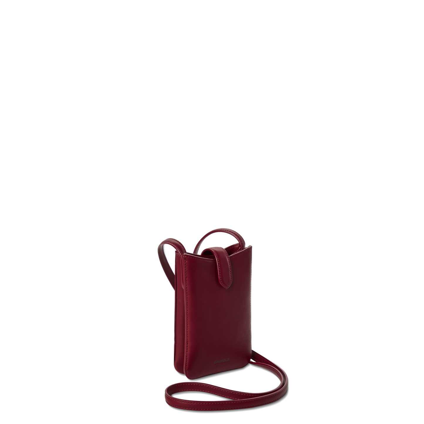The Shinola Bixby Phone Crossbody in Ruby is a compact, deep red natural leather bag with a thin strap, flap closure, and card slip pocket, shown upright against a plain white background.