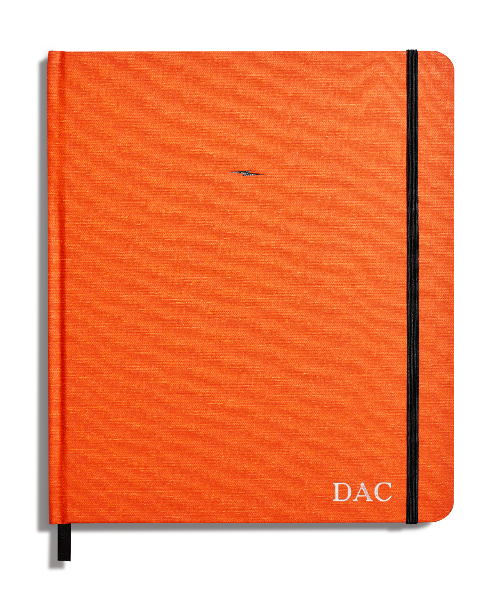 The Shinola Large Hard Plain Sketchbook in bold orange features a black elastic band on the right edge and “DAC” initials in white at the bottom right corner.