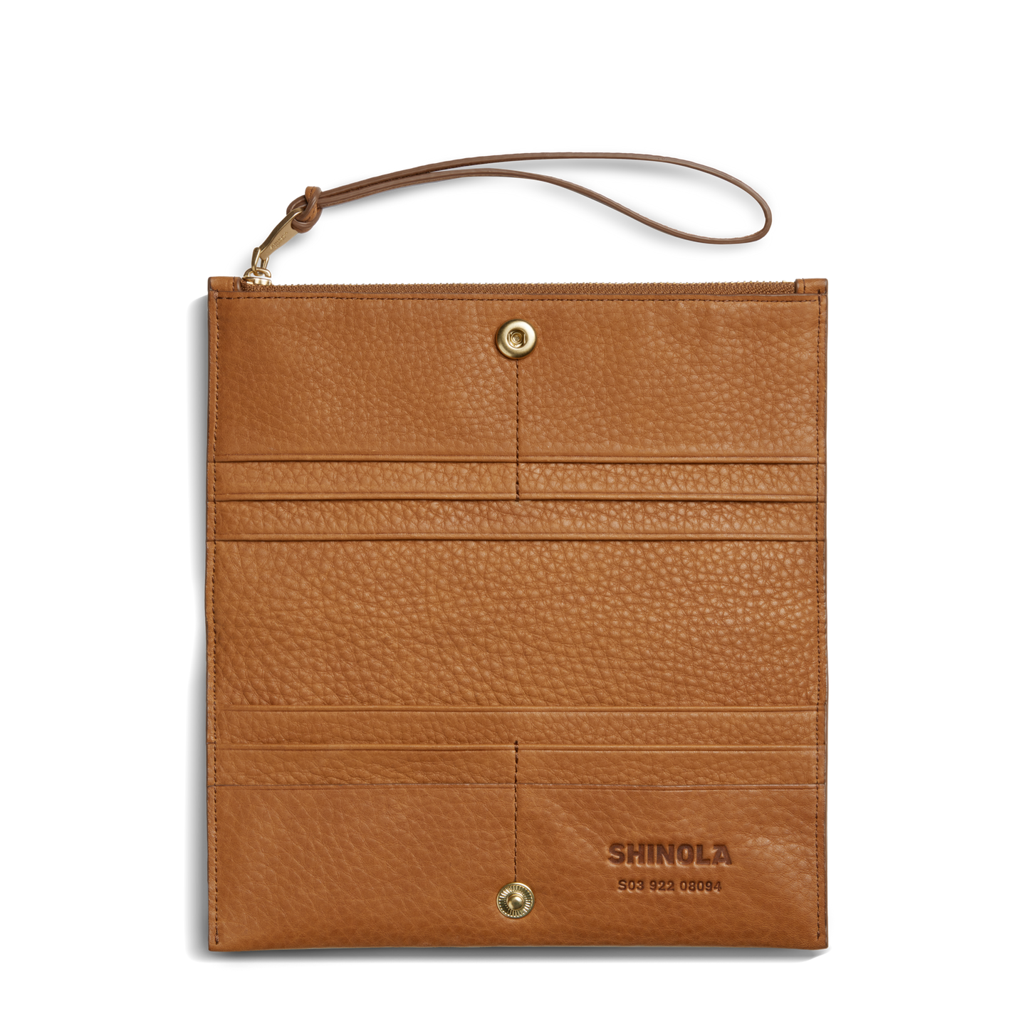 The Shinola Wristlet Wallet - Tan features natural grain leather with a textured finish, gold snap buttons, card pockets, SHINOLA embossed on the lower right, and a matching wrist strap at the upper left corner.