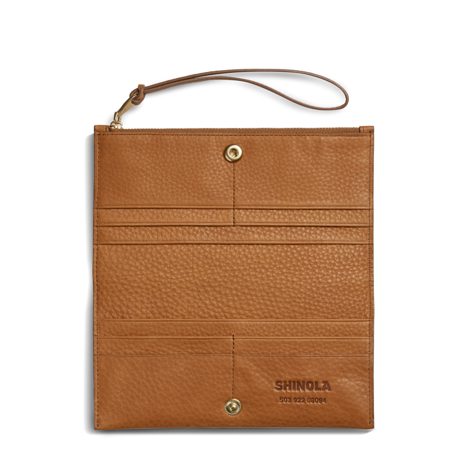 The Shinola Wristlet Wallet - Tan features natural grain leather with a textured finish, gold snap buttons, card pockets, SHINOLA embossed on the lower right, and a matching wrist strap at the upper left corner.