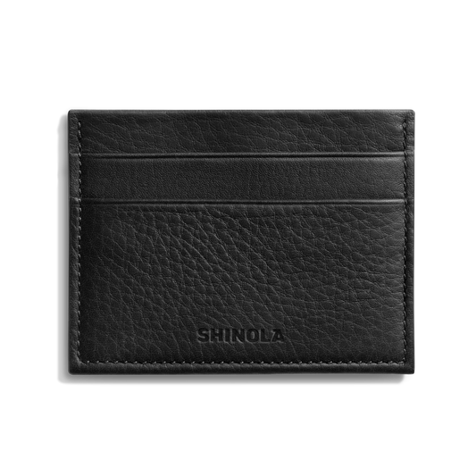 The Shinola 5 Pocket Card Holder in black leather features two horizontal card slots and SHINOLA embossed on the front, combining sleek style and convenience. Displayed against a white background.