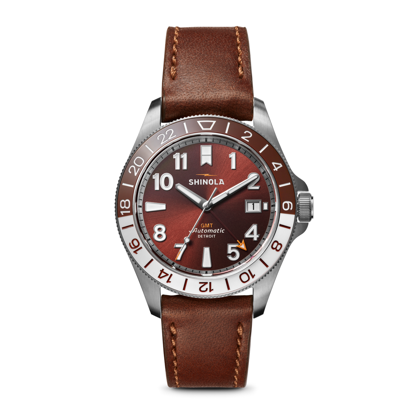 The Shinola Monster GMT Automatic Watch - Whiskey features a brown leather strap, silver case, red-brown gradient dial, white/silver markers, and date window—a sophisticated travel watch for the modern explorer.
