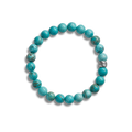 The Shinola 8mm Beaded Bracelet Turquoise features polished turquoise beads and a sterling silver accent engraved with “SHIN,” shown on a plain white background.