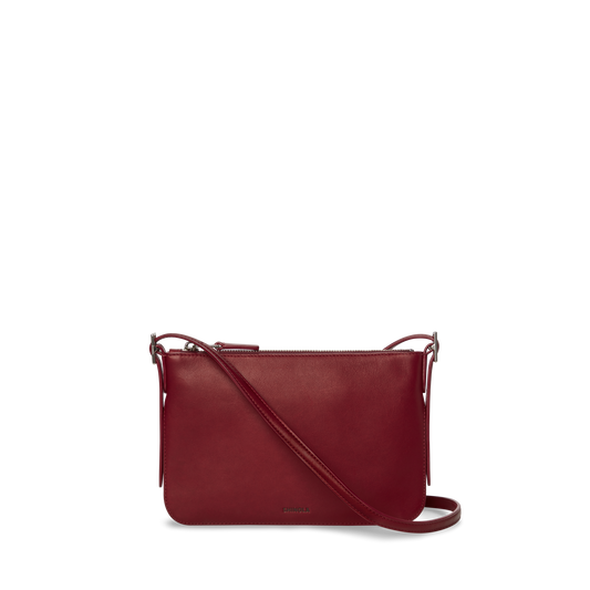 The Shinola Small Bixby Crossbody - Ruby is a sleek, rectangular natural leather bag in dark red with a long strap and top zipper, perfect for daily use, shown against a plain white background.