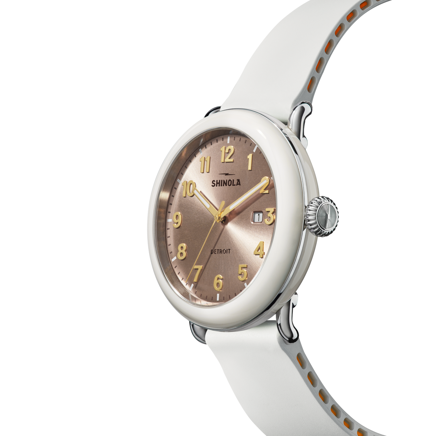 The Shinola Detrola Watch - Nude features a round face, gold-tone hour markers and hands, date window, and a white case with matching band—combining modern style with classic American design.