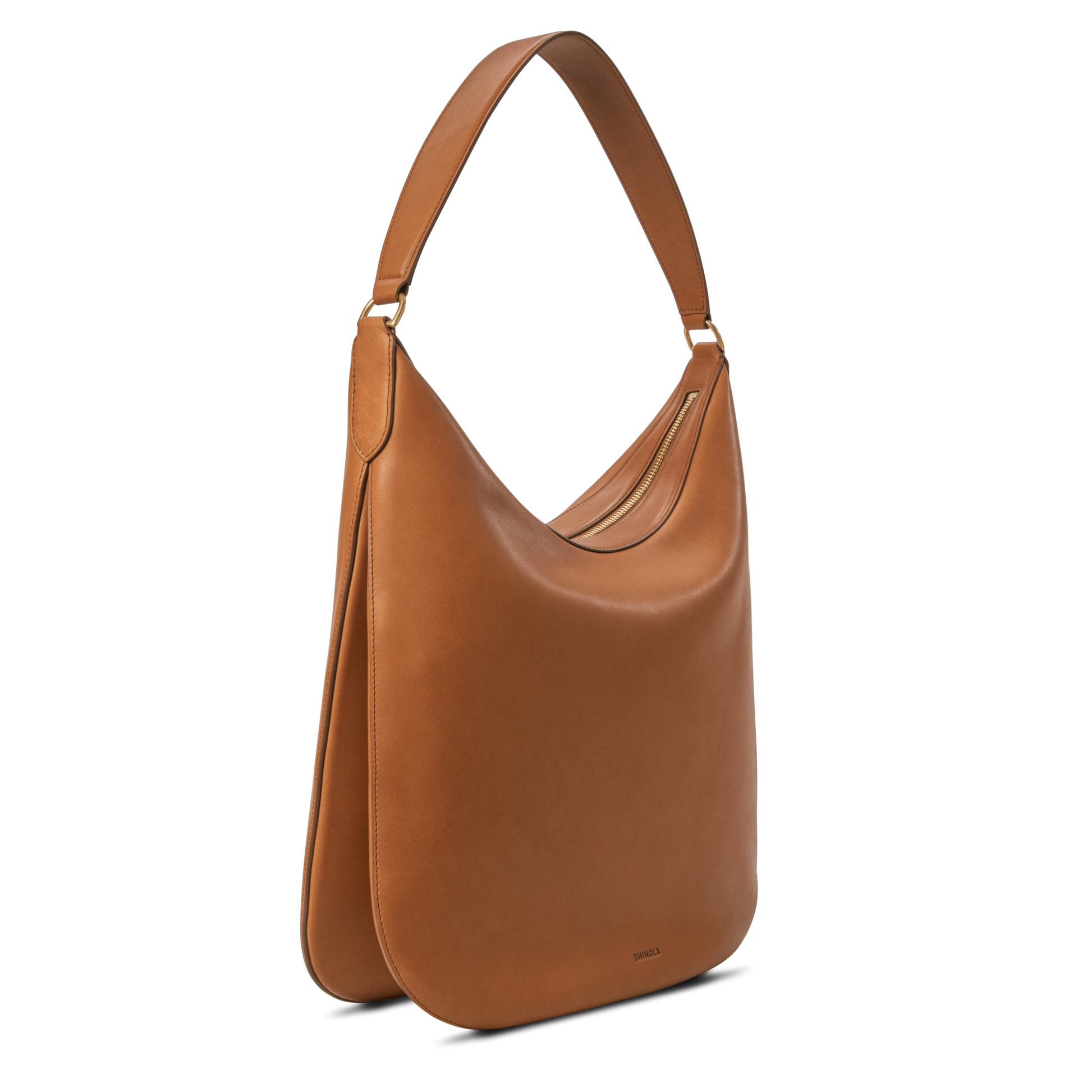 The Shinola Bixby Shoulder Bag - Tan features accordion-style construction and a wide strap, crafted from natural leather in a minimalist tan design, shown on a white background.