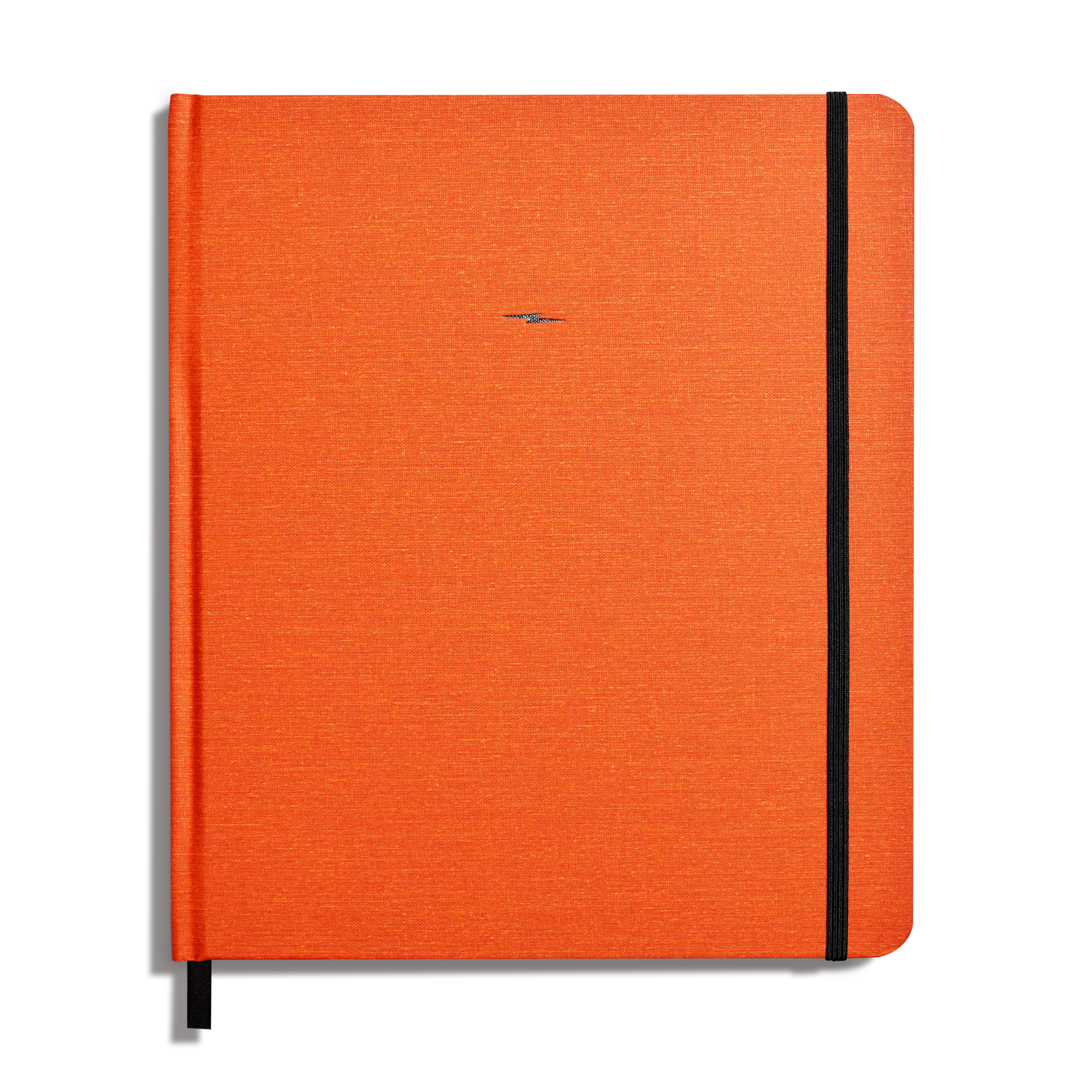The Shinola Large Hard Plain Sketchbook in Bold Orange features a linen hardcover, a vertical black elastic band on the right edge, and a discreet centered logo on the front.