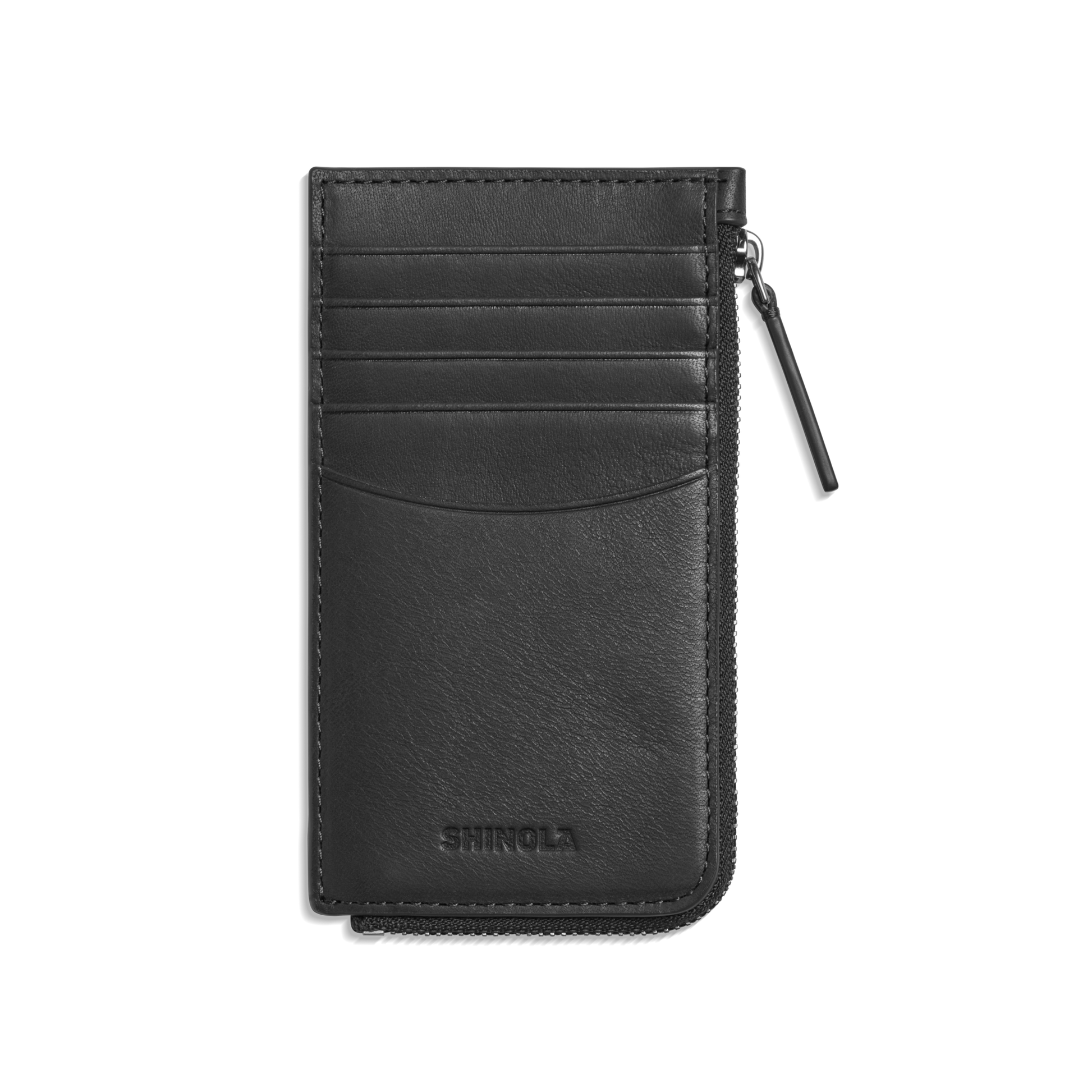 The Shinola Continental Zip Wallet - Black features natural grain leather, four card pockets, a right-side zip compartment, and SHINOLA embossed at the bottom in a sleek, minimalist design.