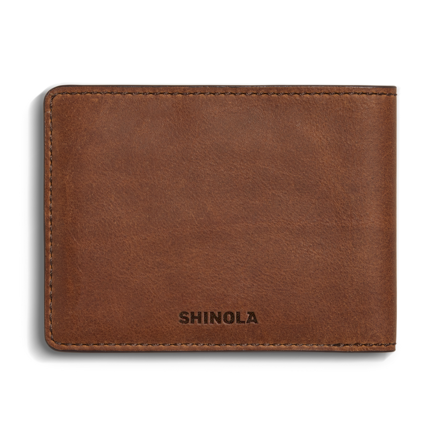 The Slim Bifold Wallet - Medium Brown by Shinola is crafted from premium leather, with visible stitching and SHINOLA embossed on the lower front corner.