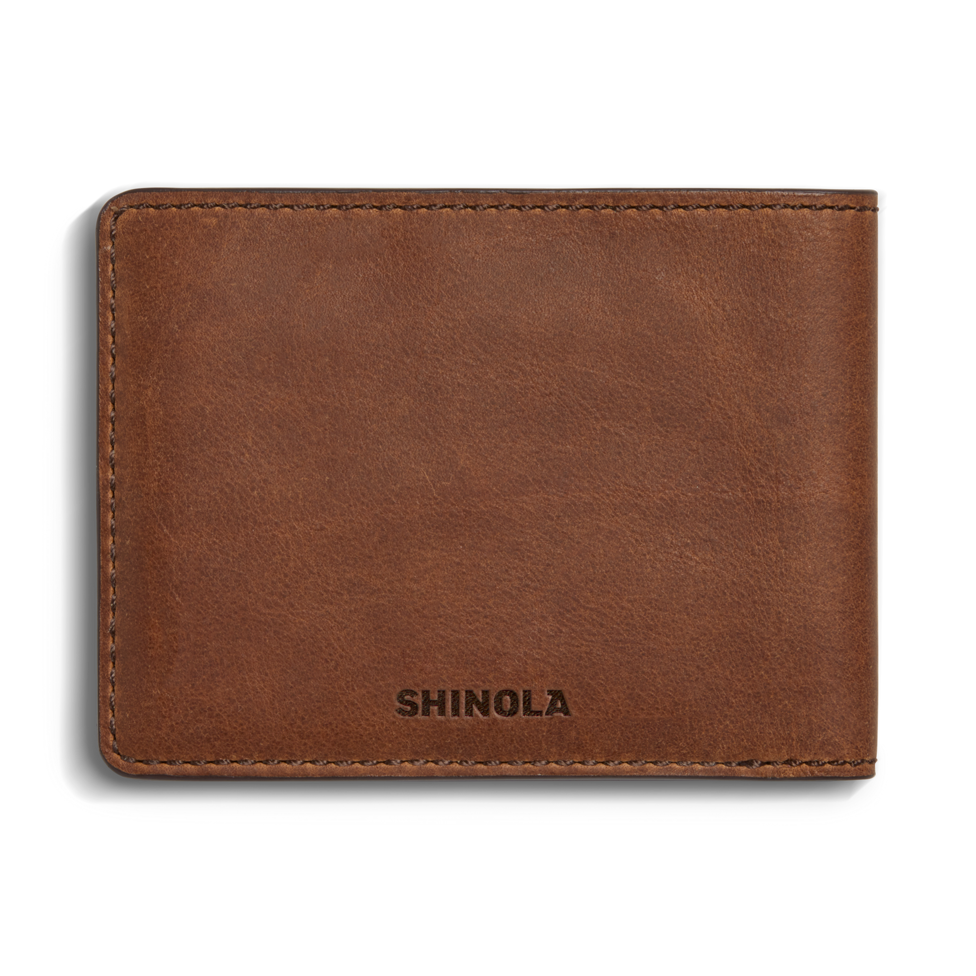 The Slim Bifold Wallet - Medium Brown by Shinola is crafted from premium leather, with visible stitching and SHINOLA embossed on the lower front corner.