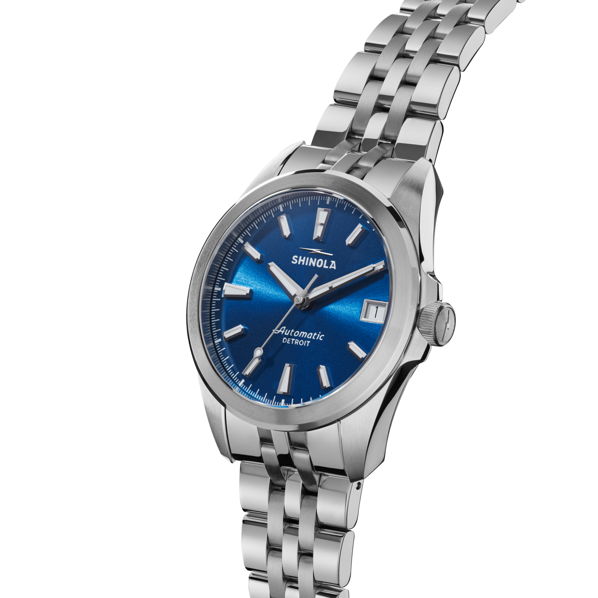 The Shinola Circadian Monster Automatic Watch - Daylight Blue features a stainless steel case, blue dial, silver hour markers, date window, automatic movement, and a linked metal band. The Shinola logo is displayed above the center.