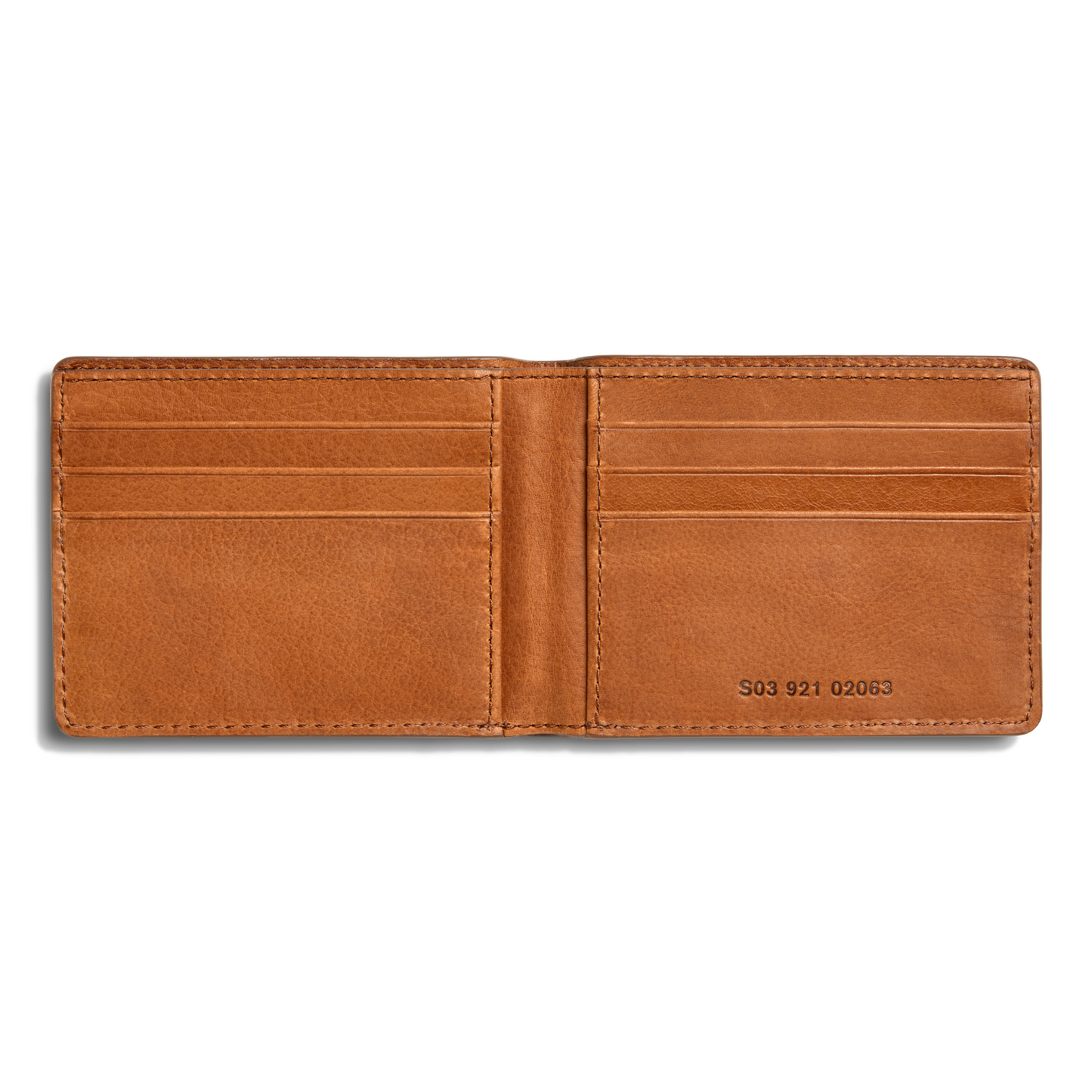 The Shinola Slim Bifold Wallet - Tan features premium brown leather, six card slots, and a visible serial number inside on the lower right. Its clean interior is showcased in a photo taken against a white background.