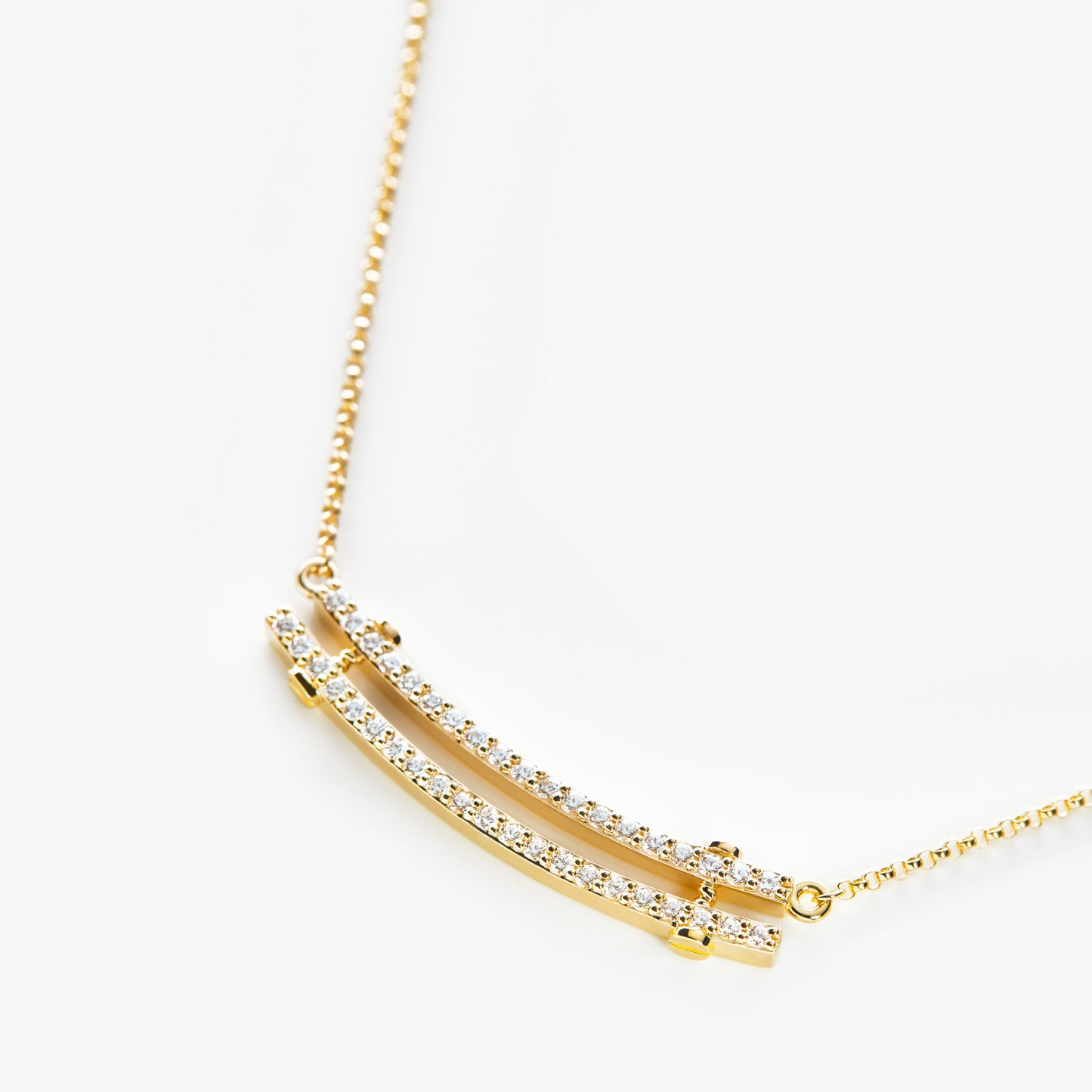The Shinola Diamond Pave Rivet Double Row Necklace in 14k Yellow Gold features two curved, parallel bar pendants with diamond pave detail, joined by a fine chain and shown on a plain white background.